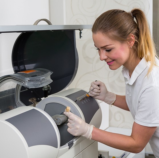 Dental team member placing ceramic in CEREC milling unit