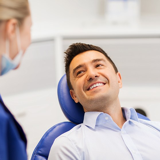 Man smiles at dentist