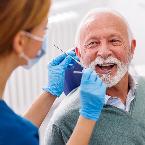 Man smiles at dentist