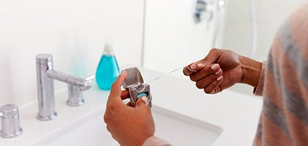 Patient removing floss from container